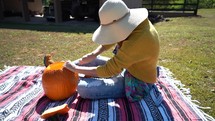 Girl cutting Pumpkin