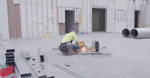 a man sawing metal beams 