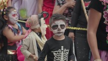 Oaxaca, Mexico - November 1, 2023: Day of The Dead Dia de Los Muertos Carnaval Street Parade. People wear Costumes, Sugar Skull Face Painting and Music Performance 