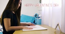 a girl coloring a red heart 