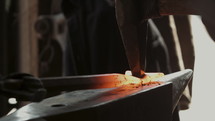 a blacksmith hammering metal 