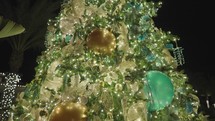 Beautiful Illuminated Christmas Tree Decoration. Colorful Blue Round Balls, Golden Ribbons, Starfish and Sea Shell Ornaments. Close Up.	
