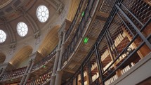 Paris, France - March 19, 2024: The Salle Ovale at the Bibliothèque Nationale de France, Richelieu an elegant oval room wood-paneled walls and beautiful ceiling, adorned with valuable book collection