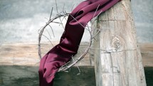 purple shroud and crown of thorns on a cross 