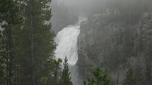 Upper Falls Waterfall View and Yellowstone River at Grand Canyon of the Yellowstone National Park, Wyoming in Morning Fog