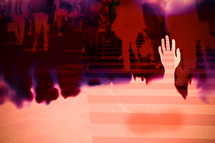 raised hands and people on a crosswalk double exposure 