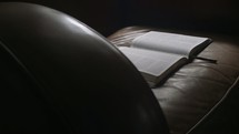 a Bible in a leather chair 
