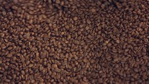 Roasted coffee beans mixed in a machine in a coffee factory