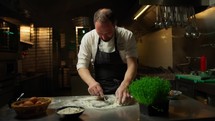 Chef Making The Dough With Flour Eggs And Cuttlefish Ink Food Into Restaurant