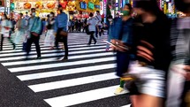 People crossing an intersection in Kabukicho entertainment district in Shinjuku, Tokyo.