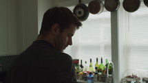 a man standing in a kitchen worrying 