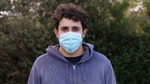 a young man wearing a face mask 