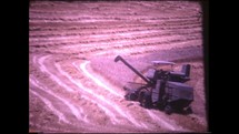 Menashe Heights, Israel, Circa 1940's. Color footage of combine harvester working in the wheat fields