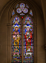stained glass windows depict biblical scenes, saints, angels, and other religious symbols.