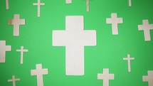 wooden crosses on a green background 
