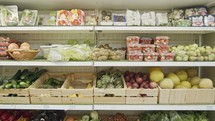 Large variety of vegetables and fruits on a supermarket shelves