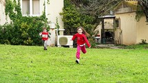 Two young kids running in slow motion towards the camera