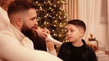 A boy talking to his father at Christmas