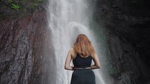 Woman Female Exploring Les Waterfall (Yeh Mempeh or Flying Waterfalls) in Tejakula Village, Buleleng, Bali - Secluded Cascade Surrounded by Rainforest, Cliffs Overgrown with Green Tropical Plants