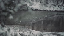 Winter snow by the river and woods