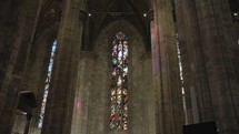 The interior details and stained glass windows inside the Duomo di Milano or Milan Cathedral or Metropolitan Cathedral-Basilica of the Nativity of Saint Mary is the cathedral church of Milan, Lombardy, Italy.