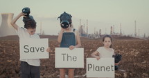climate change crisis. Kids wearing gas masks near an oil refinery