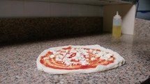 Pizza Chef Adding Basil Leafs On Margherita Dough