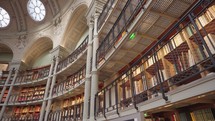 Paris, France - March 19, 2024: The Salle Ovale at the Bibliothèque Nationale de France, Richelieu an elegant oval room wood-paneled walls and beautiful ceiling, adorned with valuable book collection