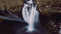 water flowing off a steep cliff in a waterfall 