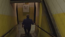 a man walking down a stairwell 