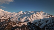 Snowy mountains in Albanian alps, aerial drone view at sunset