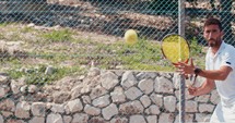 A tennis player hitting the ball during a tennis game