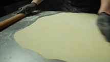 Chef Rolls Out Thin Pastry To Make Tortellini Bolognese In A Restaurant