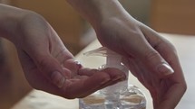 Corona pandemic - kids hands using hand sanitizer to prevent coronavirus spread