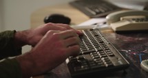 Male hands typing on a computer keyboard and touching the mouse