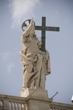 statue of Jesus holding a cross
