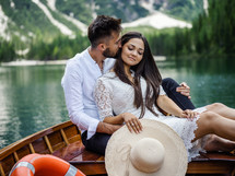 a couple cuddling on a rowboat 