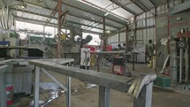 Slow motion of a welder welding construction steel frames in a construction facility