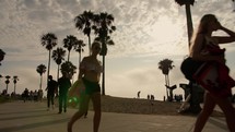 people walking at Venice beach at sunset