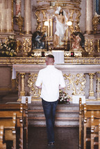 a man praying at an altar 
