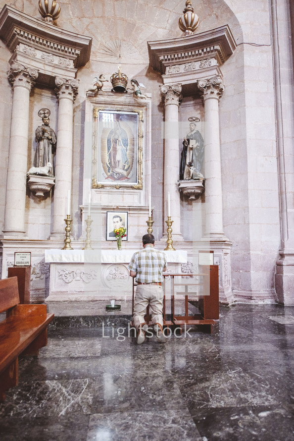 man praying at an altar 