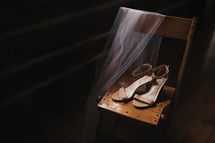 high heels on a chair with a veil 