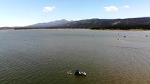 Aerial Shot Ascending Over Big Bear Lake with Boats in View