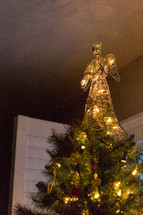straw angel on top of a Christmas tree 