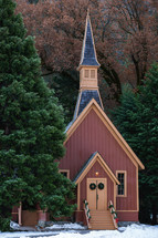 Small church at Christmas with tree