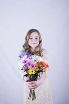a girl holding a bouquet of flowers 