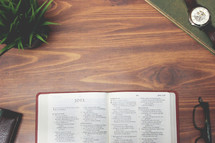 open Bible and reading glasses on a wood table - Joel 