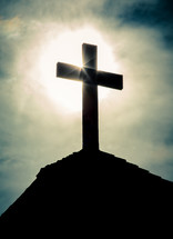 sunlight shining on a cross 