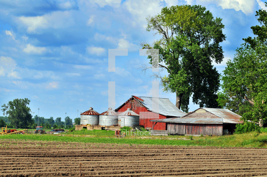 Farm with a barn and silos.