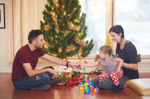 a family decorating a Christmas tree